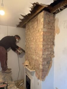 buuilding contractor removing chimney stack